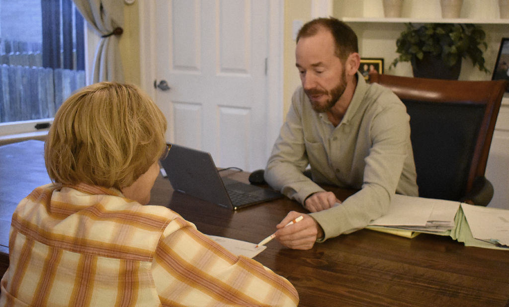 Mike Wink consulting with a client at The Wink Law Firm